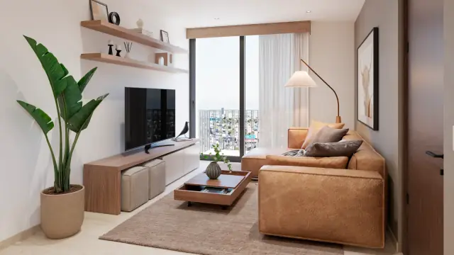 Sala iluminada de un departamento con ventanal, sofa y mueble de television